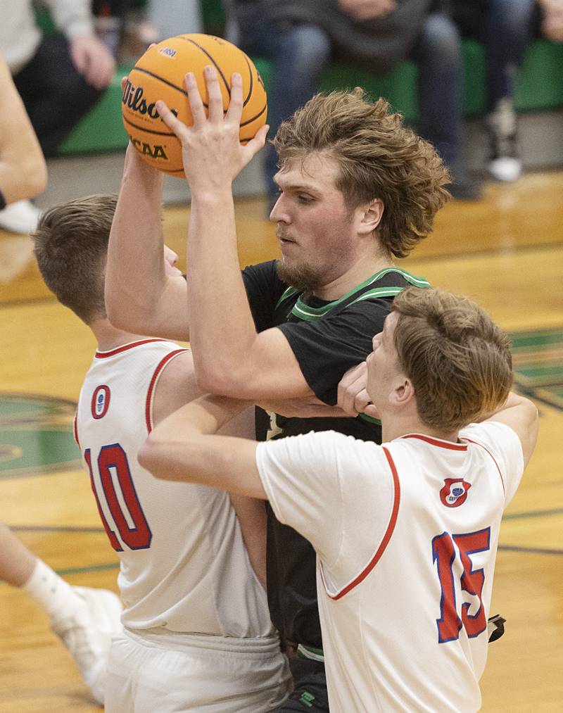 Rock Falls’ Cole Mulnix works against Oregon’s Keaton Salsbury (left) and Brian Wallace Wednesday, Feb. 25, 2026, in the Class 2A regional semifinal at Rock Falls High School.