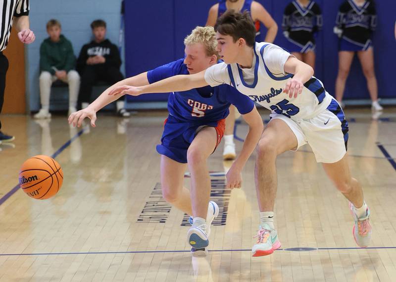 Genoa-Kingston's Blake Ides (left) and Hinckley-Big Rock's Alex Casanas go after a loose ball during their game Tuesday, Jan. 7, 2025, at Hinckley-Big Rock High School.