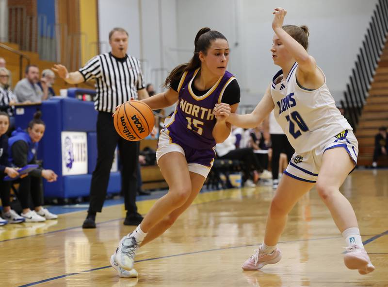 Downers Grove North'sAdysen Fanta (15) tries to get past Lyons' (20) Avery Mezan during the girls varsity basketball game between Downers Grove North and Lyons Township on Saturday, Jan. 11, 2025 in La Grange.