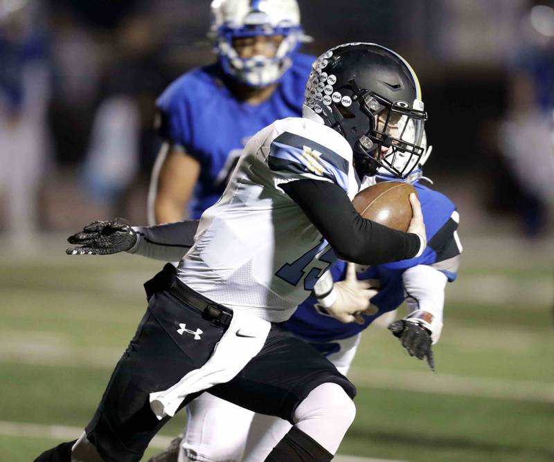 Maine West’s Thomas Delaney (15)  looks to turn upfield Friday October 28, 2022 in St. Charles.