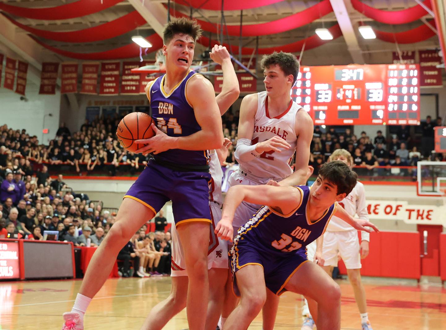Downers Grove North's George Wolkow (24) grabs a rebound during the boys 4A varsity sectional final game between Hinsdale Central and Downers Grove North high schools in Hinsdale on Friday, March 3, 2023.
