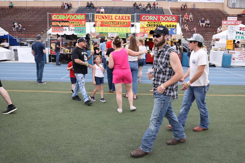 Festival goers walk past food vendors on day 2 of the Taste of Joliet. Saturday, June 25, 2022 in Joliet.