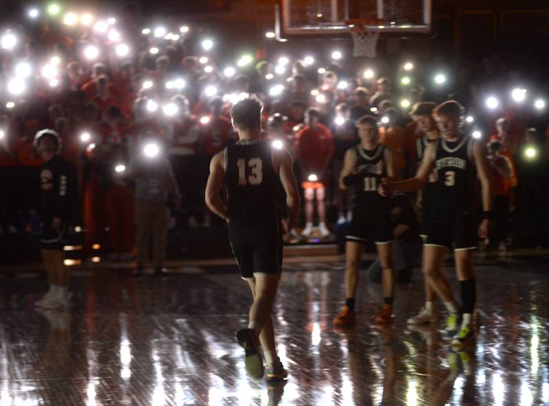 Byron's Jake Hiveley  jogs out to meet his teammates as members of the Tigers' student section use the lights on their phones during pre-game introductions at the 2A Supersectional in Sterling on Monday, March 4, 2024. The Tigers beat Chicago Latin 85-71 to advance to the state finals this week in Champaign. Byron will play Benton at 3:45 p.m. on Thursday in the semifinals. The 2A championship is scheduled for Saturday at 1 p.m.