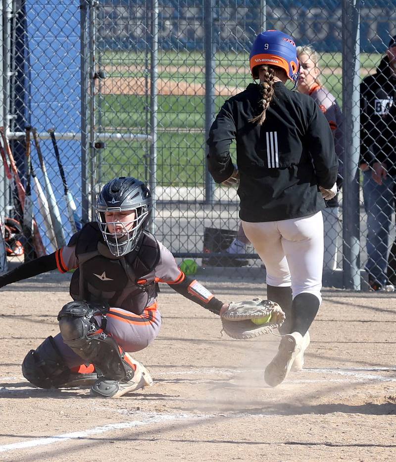 Genoa-Kingston's Olivia Vasak scores ahead of the tag by DeKalb's Madison Hallaron Thursday, May 8, 2025, during their game at Genoa-Kingston High School.