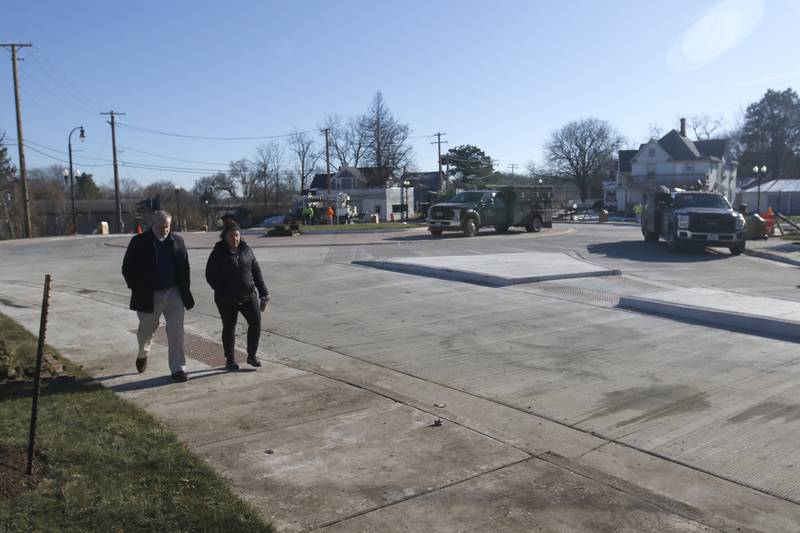 Woodstock city officials walk around the new roundabout Tuesday Nov. 22, 2022, as workers put the finishing touches on the roundabout at the intersection of Lake Avenue and South and Madison streets. Construction on the roundabout near Woodstock's downtown is expected to wrap up this week, opening traffic and marking the end of several months of construction. The roundabout has been in the works for several years and was built out this year.