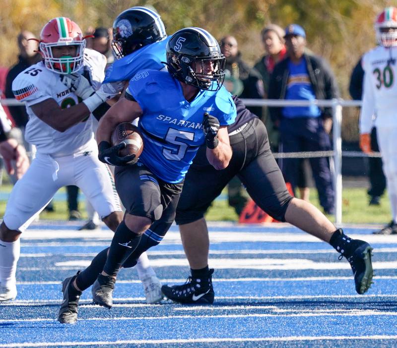 St. Francis' Dom Beres (5) runs after the catch against Morgan Park during a class 5A state quarterfinal football game at St. Francis High School in Wheaton on Saturday, Nov 11, 2023.