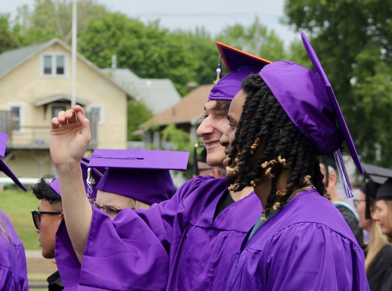 Dixon High School Class of 2023 graduates wave to the crowd on Sunday, May 28, 2023 as they get settled after the processional.