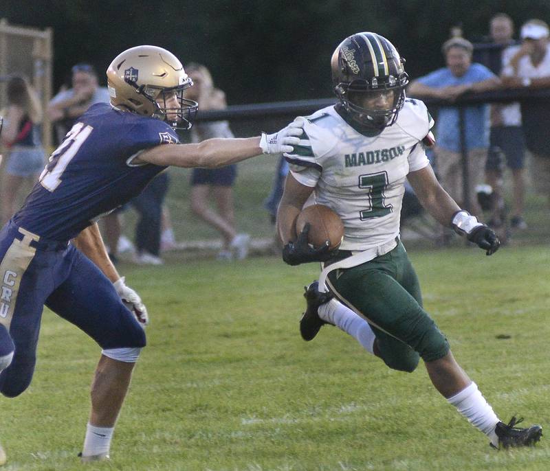 Marquette’s Charlie Mullen tries to stop Madison’s Quarter Back Isaiah Williams  on a keeper Friday in the 1st quarter at Marquette.
