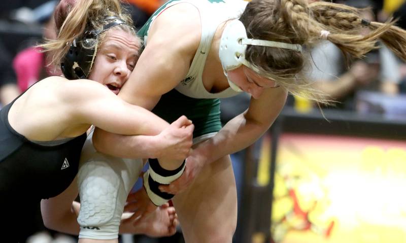 Hampshire’s Amelia Nidelea-Polanin, left, battles Glenbard West’s Karolina Konopka at 120 pounds in the title bout of  varsity girls IHSA Sectional wrestling on Saturday, February 14, 2026, at Schaumburg High School in Schaumburg.