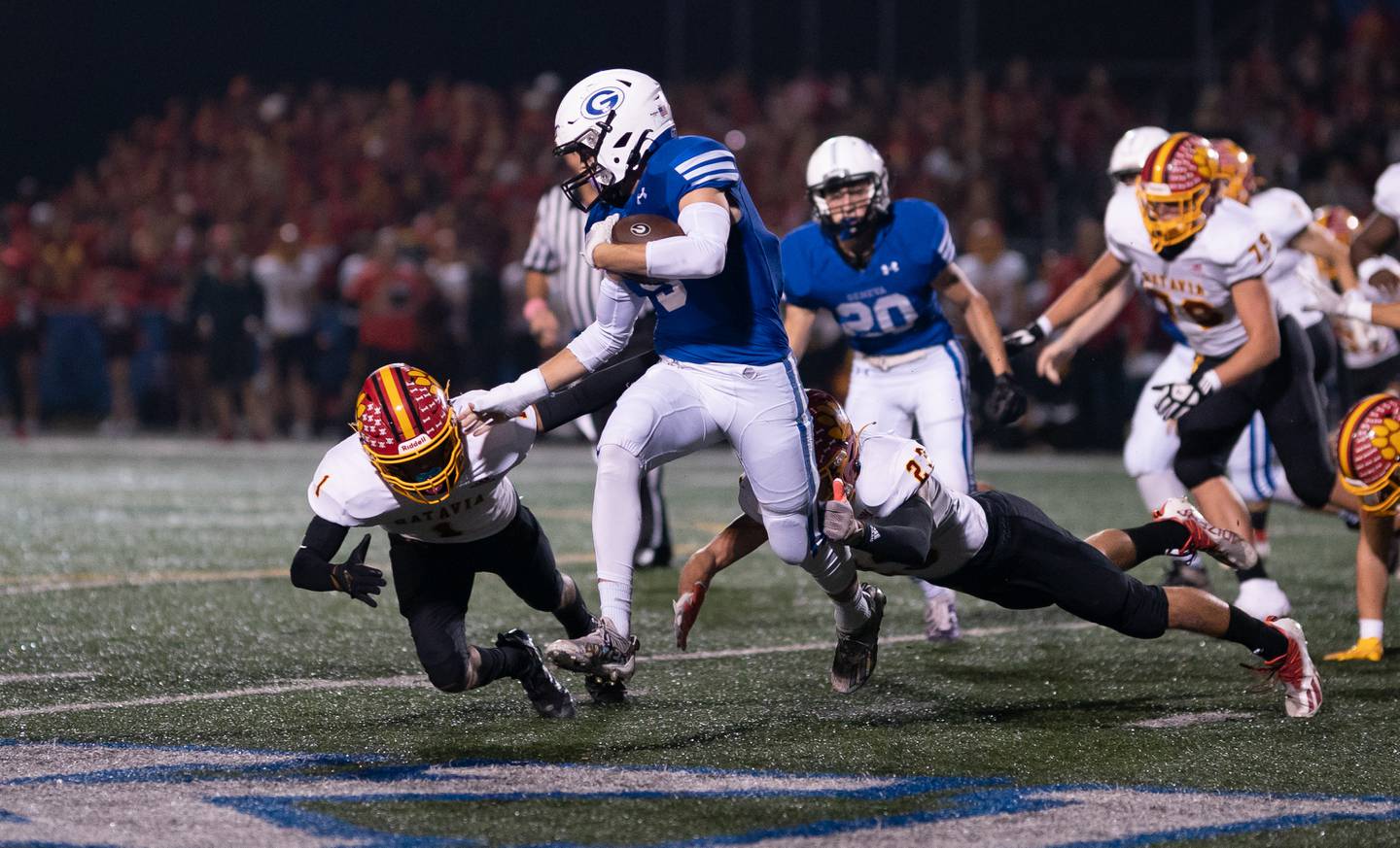 Geneva’s Carter Powelson (5) carries the ball against Batavia's Anthony Roberts (1) during a varsity football game at Geneva High School in Geneva on Friday, Oct 8, 2021.