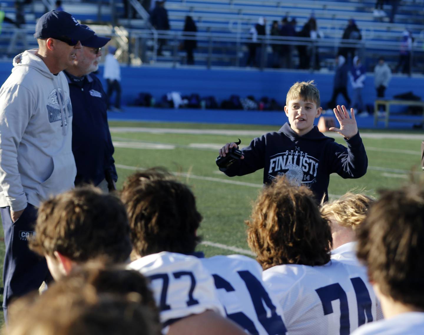 Cary-Grove Head Coach Brad Seaburg watches as his son, Kane, talks to the team after Cary-Grove defeated Lake Zurich in a IHSA Class 6A semifinal playoff football game on Saturday, Nov. 18, 2023, at Lake Zurich High School.