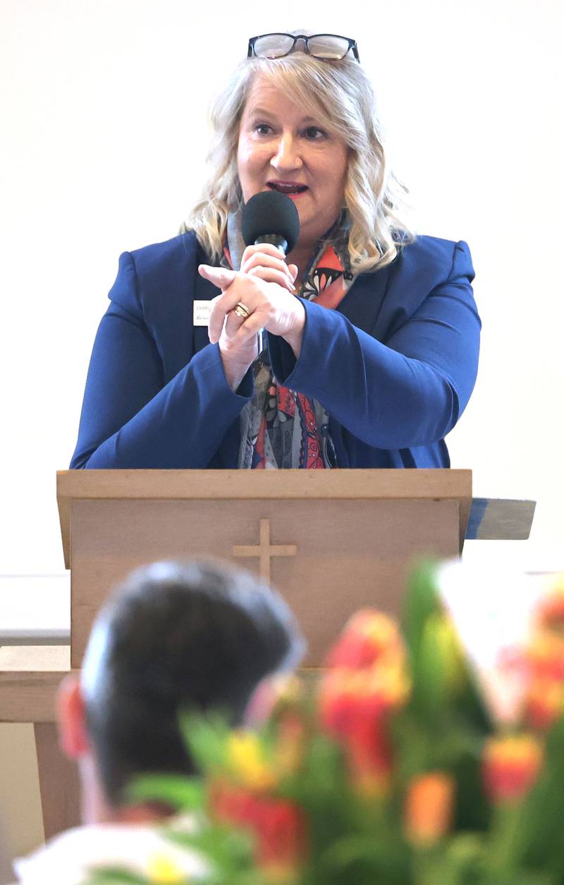 Resource Bank President and Chief Executive Officer Diana Shott acknowledges bank staff members as she accepts the Sycamore Chamber of Commerce Outstanding Business of the Year Award on behalf of the bank during the 106th Annual Chamber Meeting Thursday, March 2, 2023, in Memorial Hall at St. Mary's Catholic Church in Sycamore.