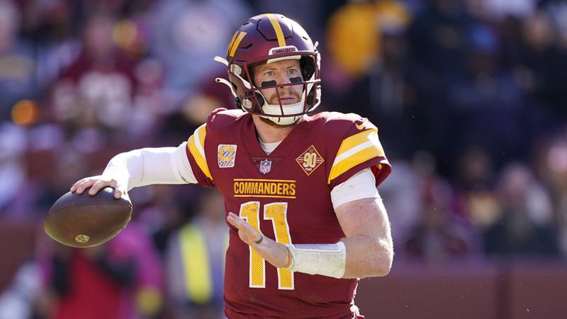 Washington Commanders quarterback Carson Wentz throws to a receiver in the second half of an NFL football game against the Tennessee Titans, Sunday, Oct. 9, 2022, in Landover, Md. (AP Photo/Alex Brandon)