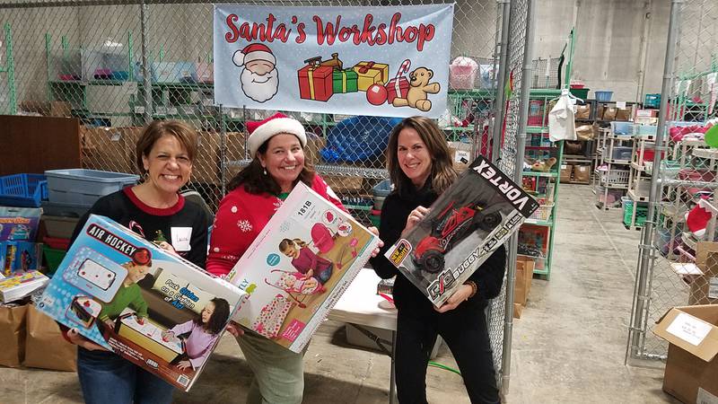 Members of the La Grange Rotary prepare prepare toys for the organization's annual Secret Santa program, which got its start in the 1920s.