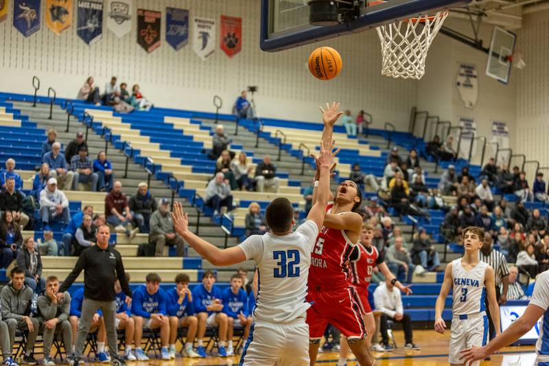 West Aurora's Richard Bell JR. goes in for the shot over Geneva's Ben Peterson on Monday, Jan. 19,2026 in Geneva.
