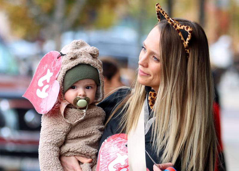 Megan Olson trick-or-treats in downtown Crystal Lake with her six-month-old son Liam on Friday, October. 31, 2025