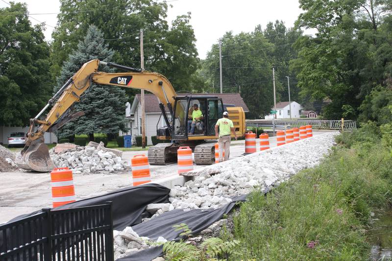 Crews replace rock along Clarks Run Creek on the site of the Utica retail plaza near the intersection of Mill and Grove streets on Wednesday, July 24, 2024 in Utica. Workers have begin replacing water lines, adding rock and preparing to redo the the Market on Mill area. The project is scheduled to be completed just before Burgoo.
