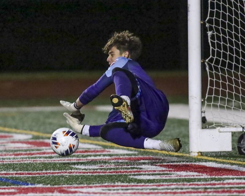 Oswego's Christian Lopez (1) dives to stop a penalty kick during Class 3A Naperville Central Regional semifinal soccer match between Plainfield North at Oswego, Tuesday Oct 21, 2025.