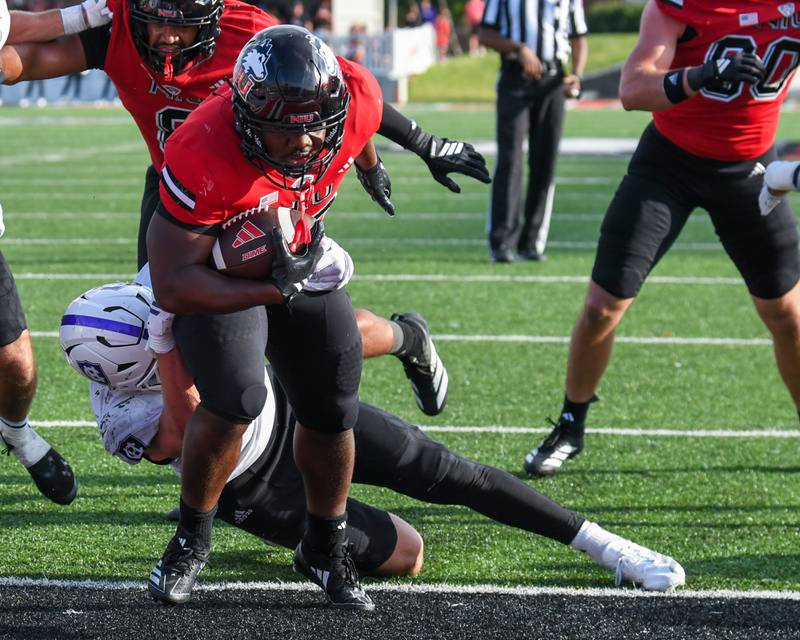 Northern Illinois University's running back Chavon Wright (10) gets through Holy Cross defenders for a touchdown during the game on Saturday Aug. 30, 2025, held at Huskie Stadium in DeKalb.