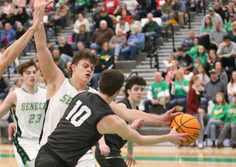 Seneca's Zeb Maxwell knocks the ball free from Woodland's Jaron Follmer on Friday, Feb. 14, 2025 at Seneca High School.
