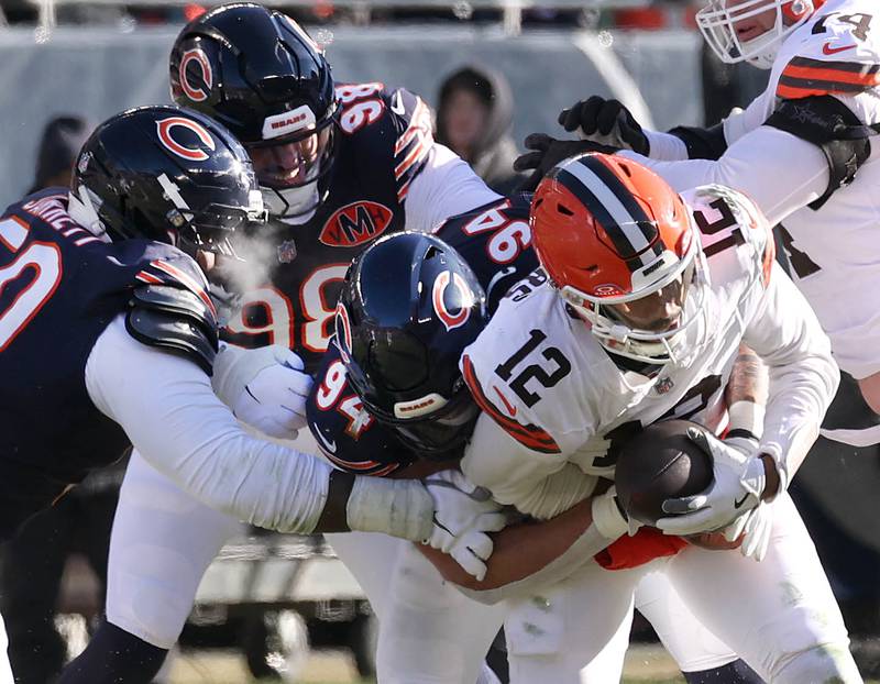 A trio of Chicago Bears defenders sack Cleveland Browns quarterback Shedeur Sanders during their game Sunday, Dec. 14, 2025, at Soldier Field in Chicago.
