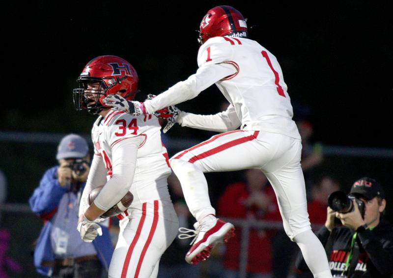 Huntley’s Haiden Janke, left, is greeted by Bryce Walker after a Janke touchdown against Prairie Ridge in varsity football at Crystal Lake Friday night.