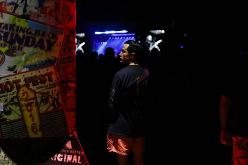 A festival goes stands in the back while listening to the Foo Fighters on day one of Riot Fest, Friday, Sept. 15, in Chicago.