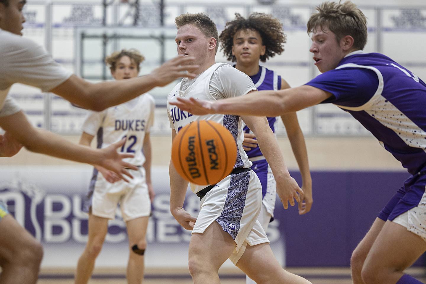 Dixon’s Eli Davidson dishes off a pass to Dixon’s Darius Harrington against Rochelle Monday, Dec. 9, 2024, at Dixon High School.