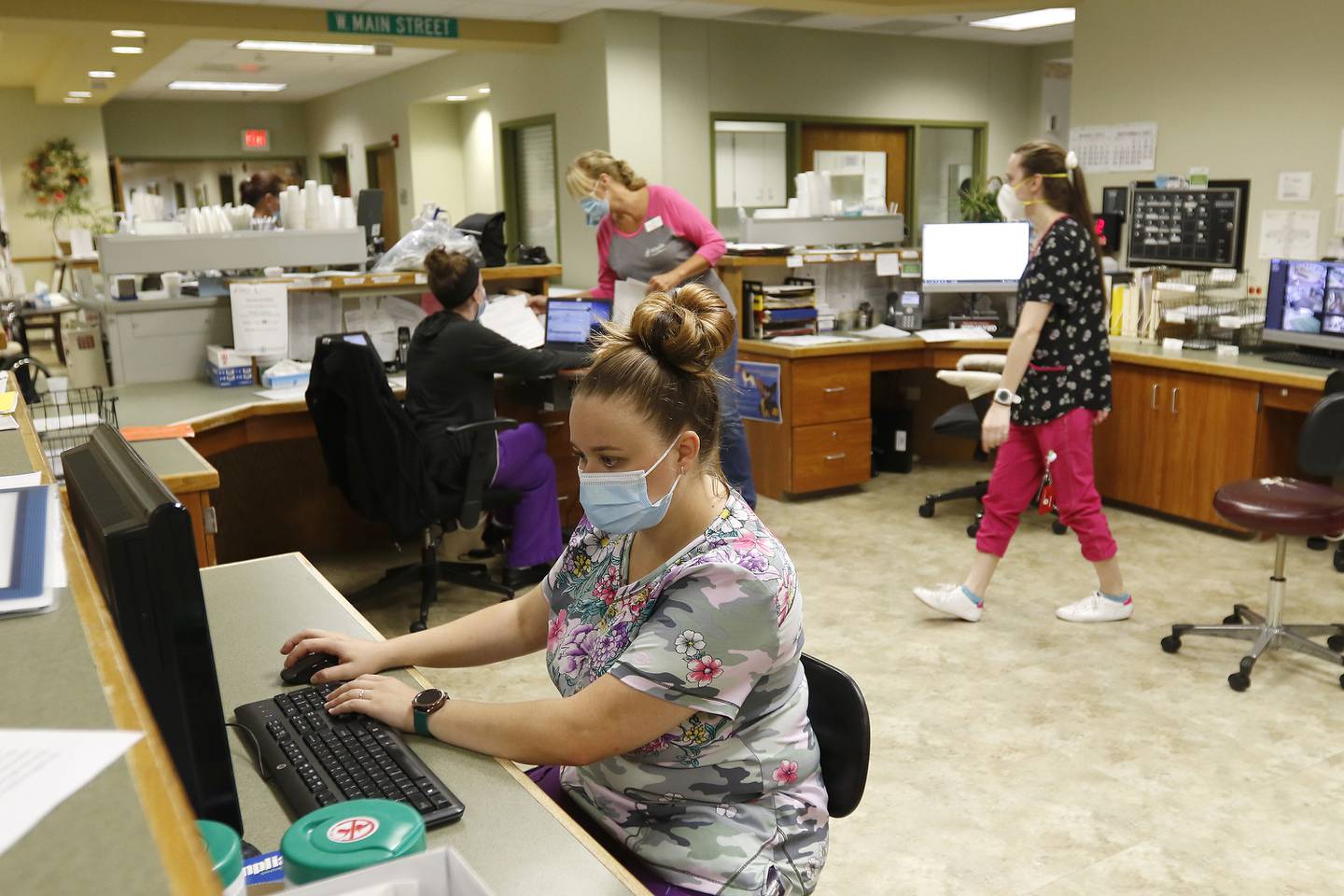 Jessica Vrasich, a certified nursing assistant, works at the nurses station at Valley Hi Nursing Home on Tuesday, Aug. 17, 2021, in Woodstock.