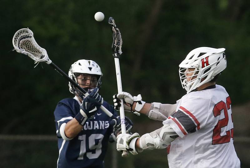 Huntley's Dominic Scarpelli (right) passes the ball as Cary-Grove's Wyatt Judge defends during the Marian Central Sectional boys lacrosse semifinal match on Wednesday, May 28, 2025, at Marian Central High School in Woodstock.