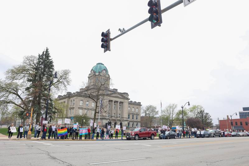 Over 250 fill the sidewalk holding signs as they participate in the Hands Off Rally at the Kankakee County Courthouse on Saturday, April 19, 2025.