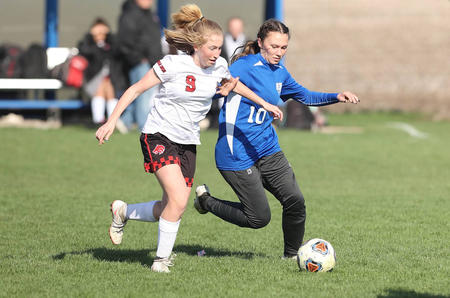 Indian Creek's Jolee Larson and Hinckley-Big Rock/Somonauk's Josie Rader try to get to the ball first during their game Tuesday, April 26, 2022, at Hinckley-Big Rock High School.