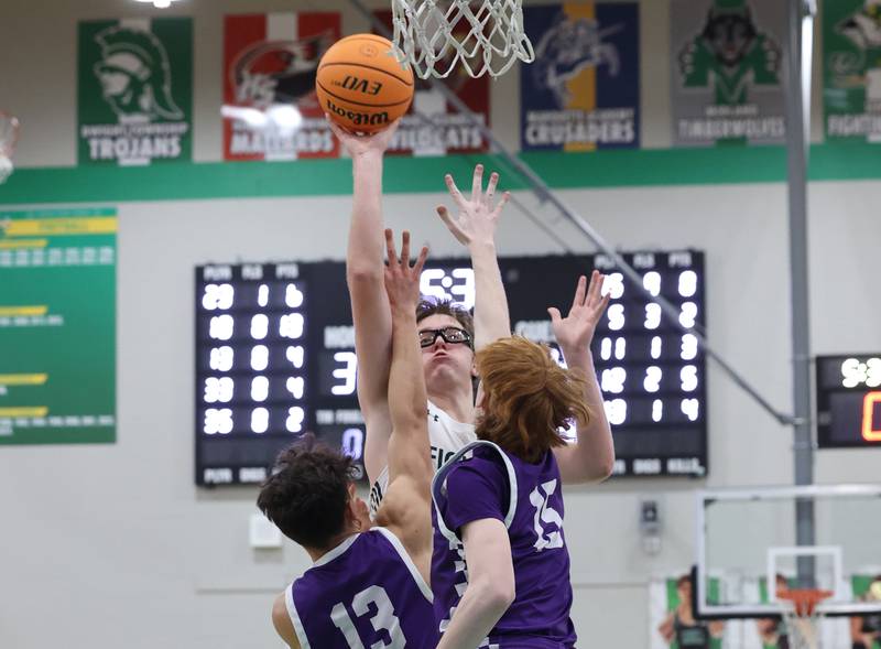Bishop McNamara's Callaghan O'Connor puts up a shot under pressure from Wilmington's Hunter Kaitschuck (13) and Tyler Krand during Bishop McNamara's 61-24 victory over Wilmington in the IHSA Class 2A Seneca Sectional semifinal on Tuesday, March 3, 2026.