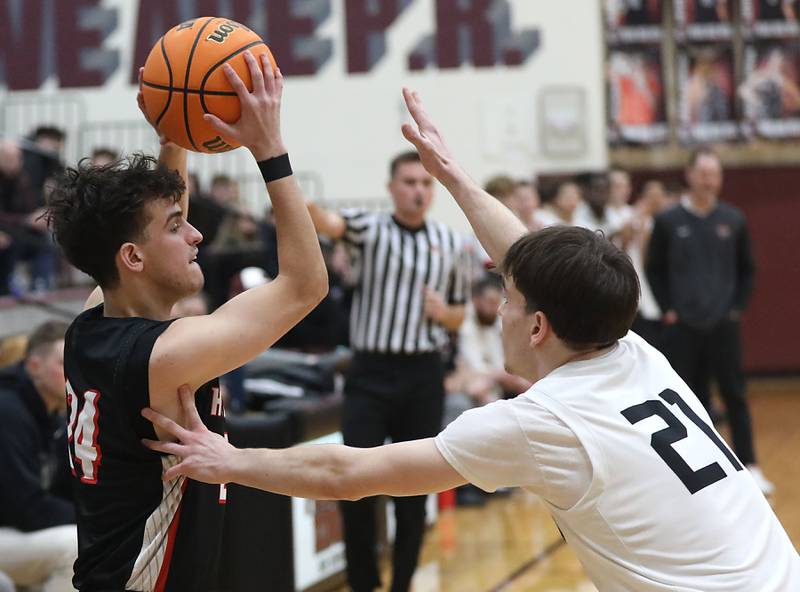 Huntley's Casey Kaczmarski looks to pass as he is guarded by Prairie Ridge's Brendan Beu during a Fox Valley Conference boys basketball game on Wednesday, Jan. 21, 2026, at Prairie Ridge High School in Crystal Lake.