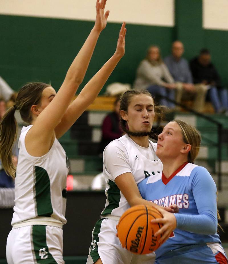 Marian Central's Abbey Miner (right) drives the lane agains Grayslake Central's Katie Marcelain (left) and Peyton Hoffmann (center) during a nonconference girls basketball on Monday, Jan. 13, 2025, at Grayslake Central High School.