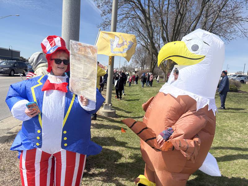 Attendee Debbie Bailey, left, wears an Uncle Sam outfit and Denise Bailey, right, wears an eagle outfit at a No Kings rally in Crystal Lake, Saturday, March 28, 2026.