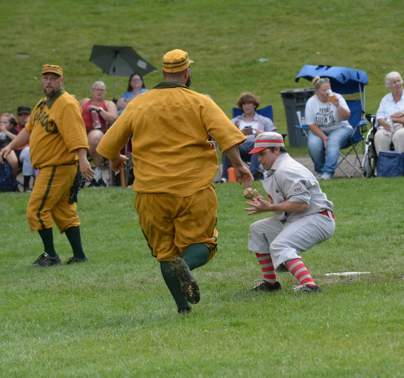 Ganymede catcher Tom Lasniak tries to hang on to the ball as a Flat Rock runner bears down on him on Saturday, Aug. 12, 2023 at the 20th Annual World Tournament of Historic Base Ball.