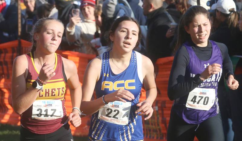 Richmond Burton's Savannah Wells, Aurora Central Catholic's Ailidzie Perez, and Wilmington's Brooklyn Flores compete in the Class 1A Cross Country Finals on Saturday, Nov. 4, 2023 at Detweiller Park in Peoria.