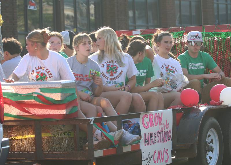 The L-P girls wrestling team rides on a float during the L-P homecoming parade on Thursday, Oct. 2, 2025 downtown Peru.