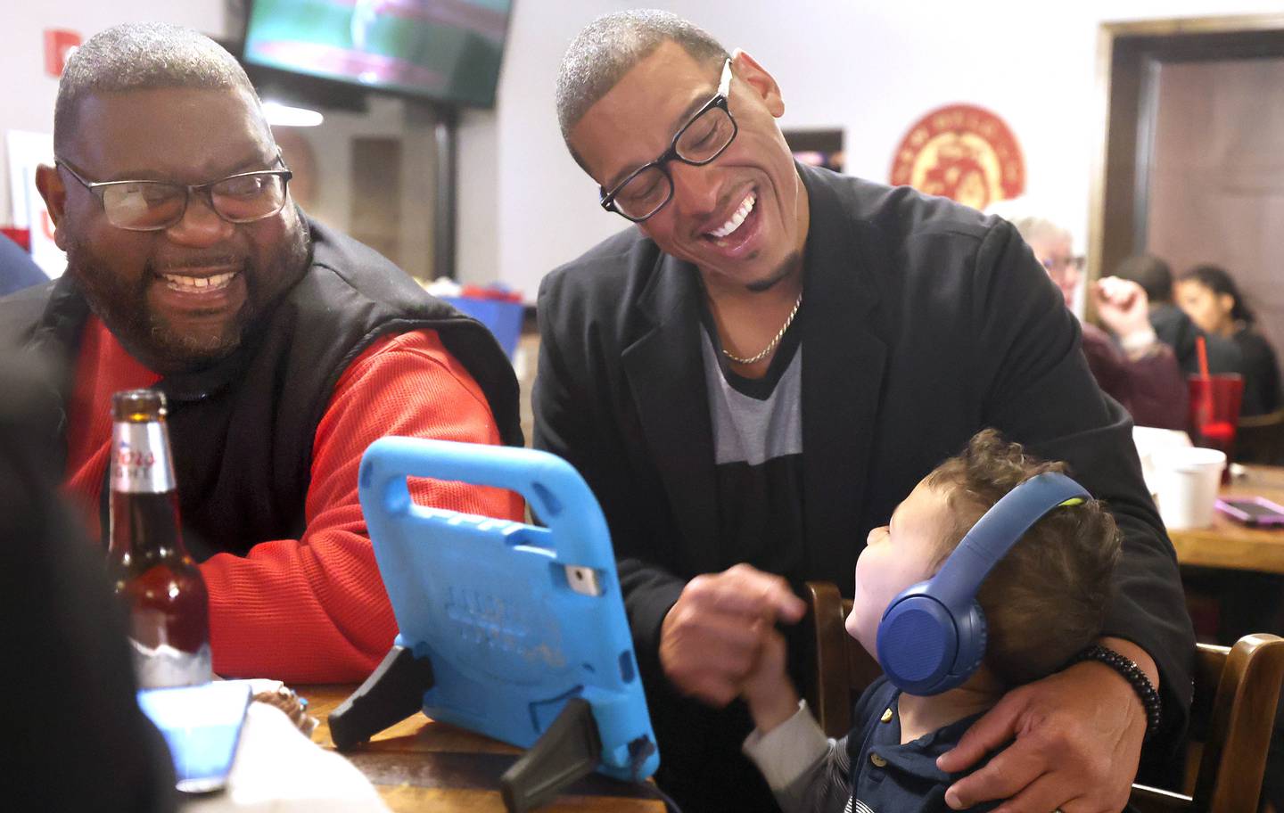 John Walker, (middle) DeKalb 7th Ward aldermanic candidate, greets friends Kaisen Gay, 2, and his dad Antwione Gay, from DeKalb Tuesday, April 4, 2023, during an election night watch party at Fatty's Pub & Grill in DeKalb.