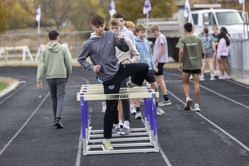 The Dixon boys cross country team warms up on the track of DHS Thursday, Nov. 6, 2025. The team is gearing up for this weekend’s state tournament.