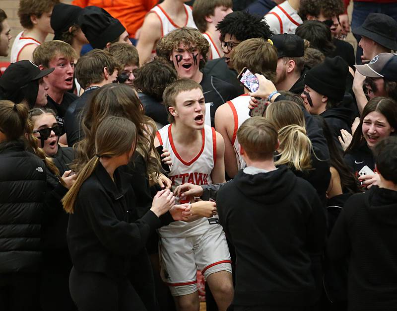 Ottawa's Huston Hart celebrates with superfans after defeating L-P in Kingman Gymnasium on Friday, Feb. 10, 2023 at Ottawa High School.