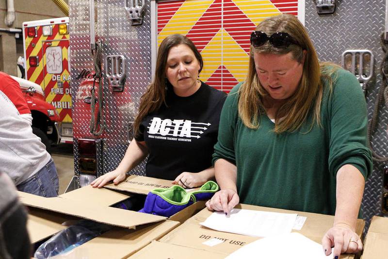 Shaw Local 2015 file photo – DeKalb Classroom Teachers Association members Liz Smith (left) and the late Amy Fontana (right) help with the Operation Warm coat giveaway in December 2015 at DeKalb Fire Station No. 1. Fontana died at 48 on Nov. 19, 2024, after a battle with cancer. She was remembered by loved ones for her devotion to DeKalb students and families.