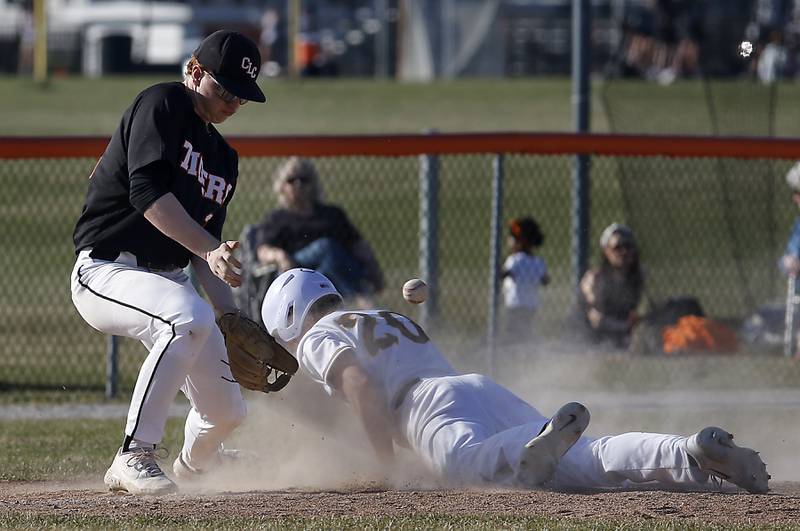 Crystal Lake Central's Rhett Ozment tries to come up with the ball as Jacobs’ Nathan Gerritsen slides into third base during a Fox Valley Conference baseball game Monday, April 10, 2023, at Crystal Lake Central High School.