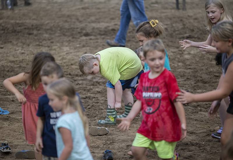 Finnegan Newman, 7, of Prophetstown slips on his boots during a kid’s race Wednesday, August 14, 2024, at the Whiteside County Fair in Morrison.