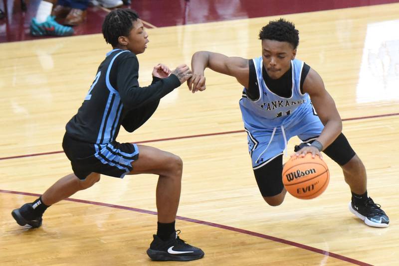 Kankakee's Dayshawn Brown, right, drives past Thornridge's Marcellus French during a game at Kankakee Friday, Dec. 5, 2025.