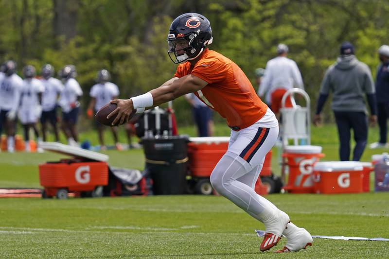 Chicago Bears quarterback Justin Fields looks to hand off the football during practice, Tuesday, May 17, 2022, at Halas Hall in Lake Forest.