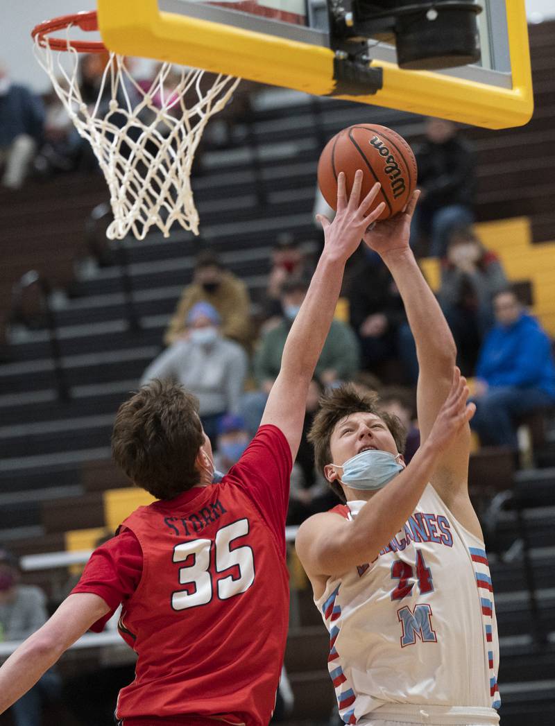 South Elgin's Michael Hankins gets a hand on the shot of Marian Central's Christian Bentancur during their game at the Hinkle Holiday Classic basketball tournament on Monday, December 27, 2021 at Jacobs High School in Algonquin.
