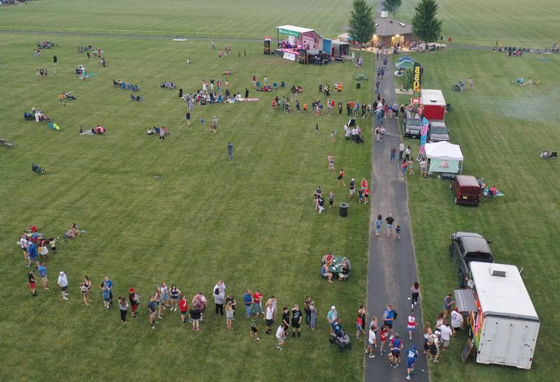 People wait for food in a long line during the Fourth of July fireworks on Thursday, July 4, 2024 at Zearing Park in Princeton.