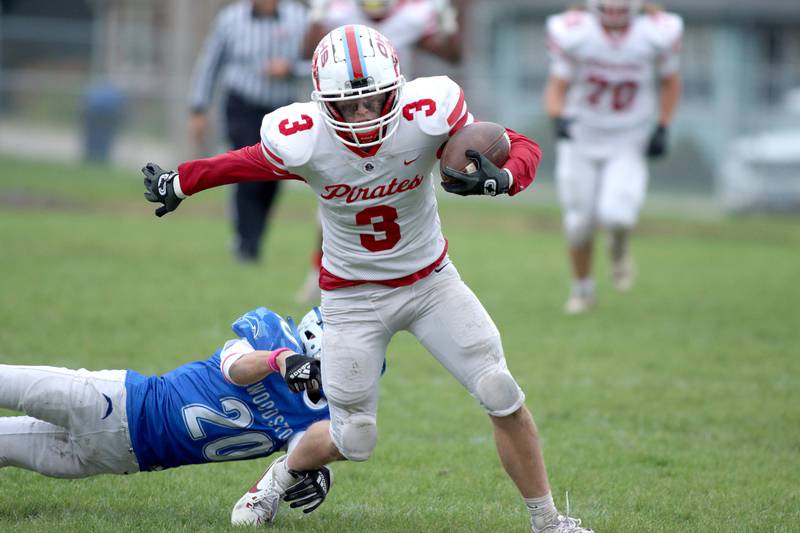 Ottawa’s Hayden Swett runs the ball in varsity football at Larry Dale Field on the campus of Woodstock High School Saturday.